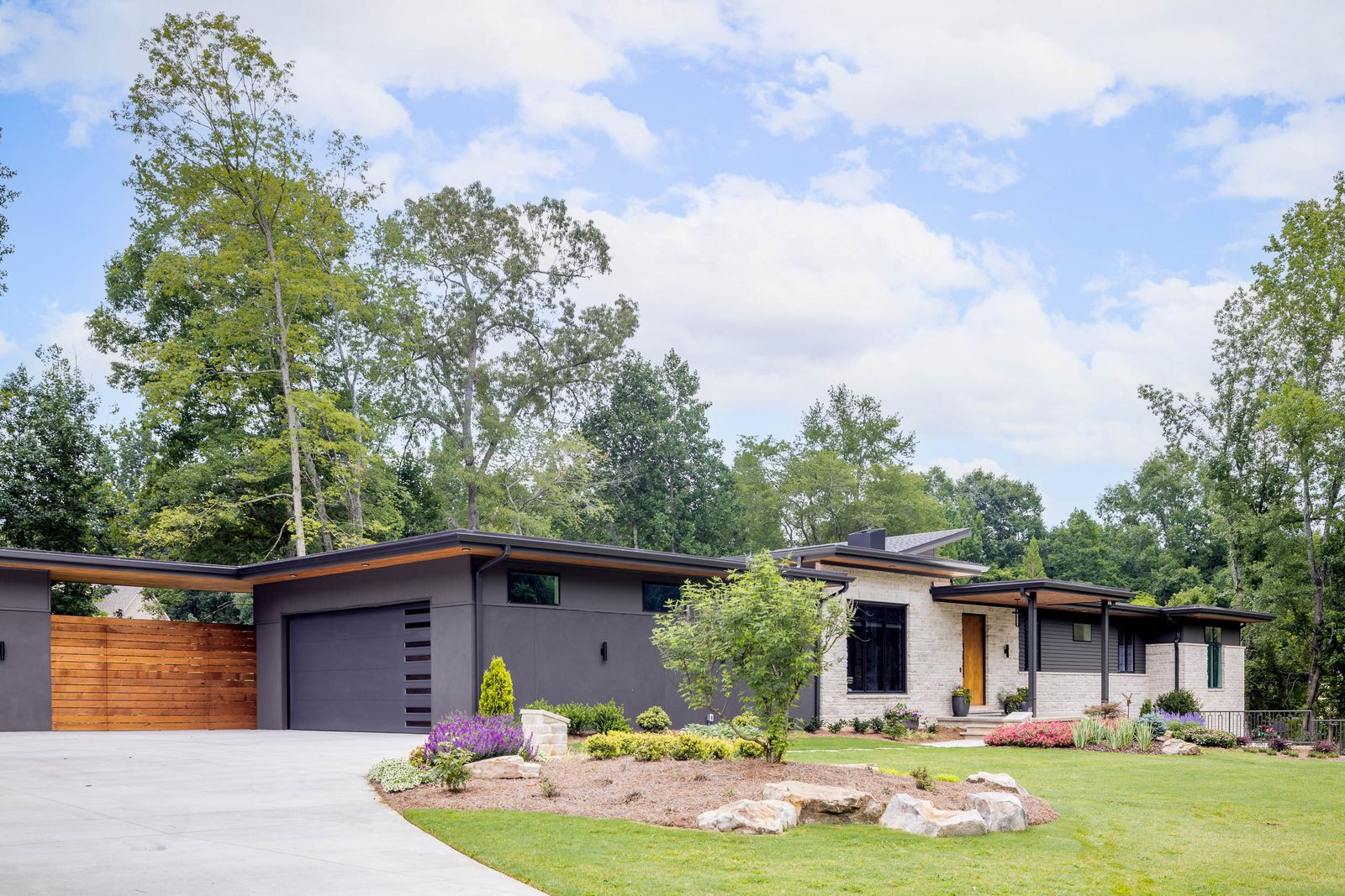 Drive court with cedar gate and garage — The Ortiz Home, custom home built by Ironwood Construction Group in Sugar Hill, Georgia